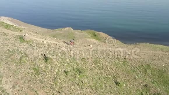 戴着安全帽的人骑在岩石坡上的山地车上夏季活动视频的预览图