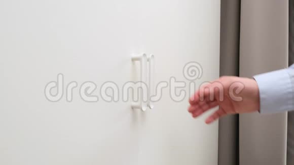 男人打开衣柜门选择一件干净的白色衬衫快关门视频的预览图