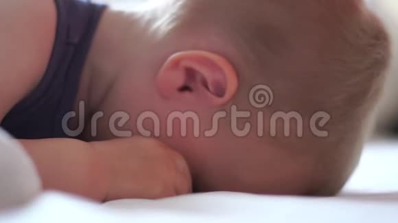一个金发小男孩在梦中缓慢地转动着头视频的预览图