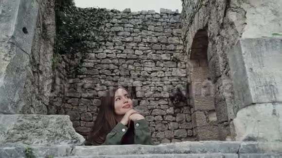 美丽的女孩看着一座古堡的窗户就像特写中的公主视频的预览图