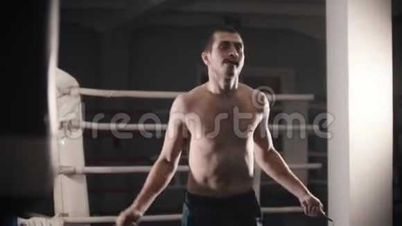 拳击训练一名男子站在拳击台上跳过跳绳视频的预览图