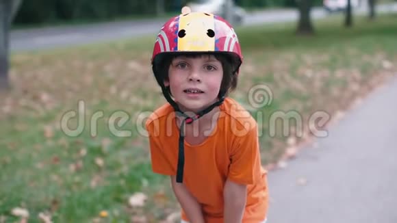 一个戴着头盔的孩子站在高速公路上的肖像视频的预览图