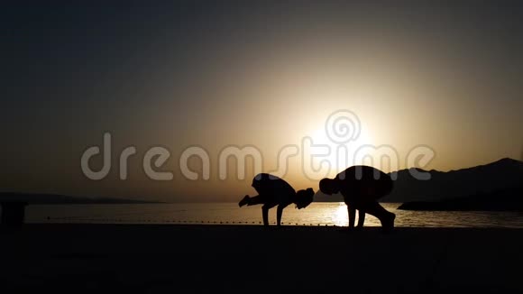 日落时在海边做瑜伽的剪影并提供免费空间视频的预览图