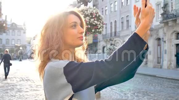 欧洲古城广场上一位女游客清晨合影留念的女性户外肖像视频的预览图