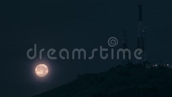 夜晚有电视塔的满月在山上视频的预览图