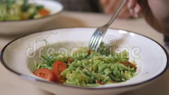 一顿素食午餐蔬菜沙拉和意大利面加绿色酱汁视频的预览图