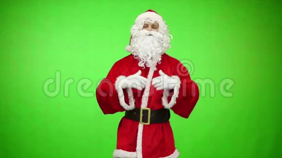 穿着红色服装的圣诞老人微笑着在绿色彩色钥匙背景上竖起大拇指圣诞节和新年视频的预览图