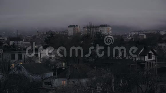 傍晚时分雾中的多层住宅楼靠近群山视频的预览图