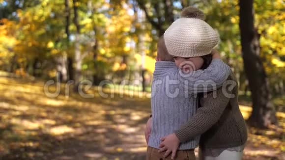 可爱的男孩拥抱患有唐氏综合症的妹妹户外视频的预览图