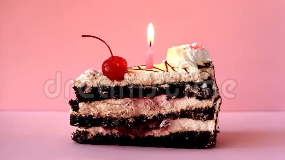 饼干篮子上面有白色糕点奶油红色鸡尾酒樱桃和一支燃烧的生日蜡烛延时录像视频的预览图