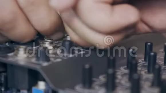 一名工人修理音响调音台的特写视频的预览图