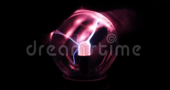 特斯拉等离子球与粉红色和蓝色闪电在人手在黑暗特写视频的预览图