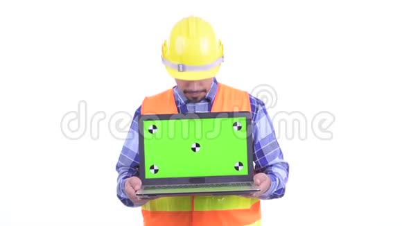 快乐的波斯人建筑工人一边说一边展示笔记本电脑视频的预览图