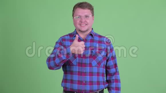愚蠢的超重的留着胡须的嬉皮士男人在竖起大拇指和竖起大拇指之间做出选择视频的预览图