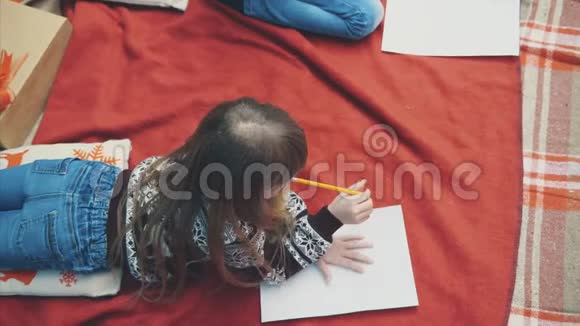 一个金发女孩在冬天躺在红毯子上想着要在写给北极的信里写些什么视频的预览图