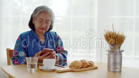 高级女性使用智能手机支付QR代码视频的预览图