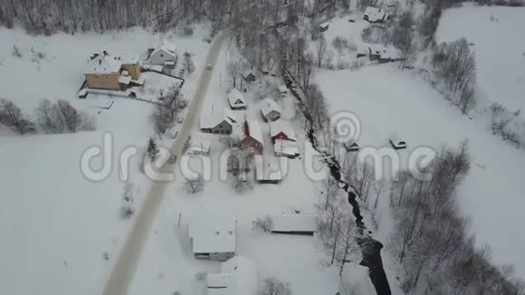 喀尔巴阡村冬季公路上行驶汽车的鸟瞰图鸟雪覆盖的房子的视野乡村景观视频的预览图