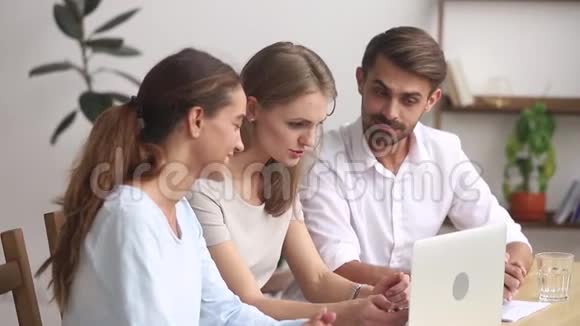 三名办公室工作人员计划一起使用笔记本电脑在线程序视频的预览图