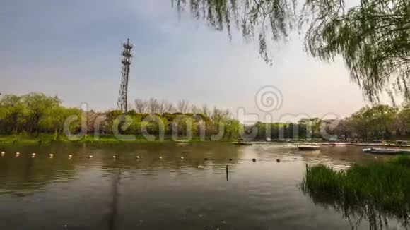 中国传统园林公园游客乘船沿河而行4K时间推移视频的预览图