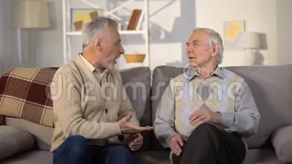 老年男性朋友在家里沙发上吵架误会冲突视频的预览图