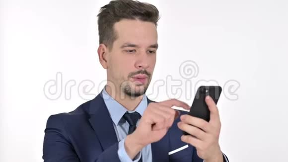 悲伤的年轻商人在智能手机上迷路的肖像白色背景视频的预览图