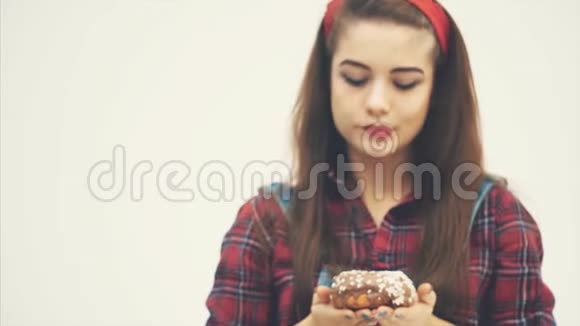 模糊可爱的年轻女性建议你品尝大巧克力甜甜圈用她的表情显示它视频的预览图