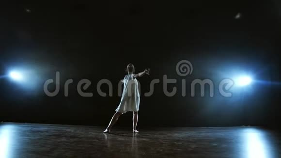 一个穿着白色连衣裙的女孩在舞台上跳舞在聚光灯下抽烟视频的预览图