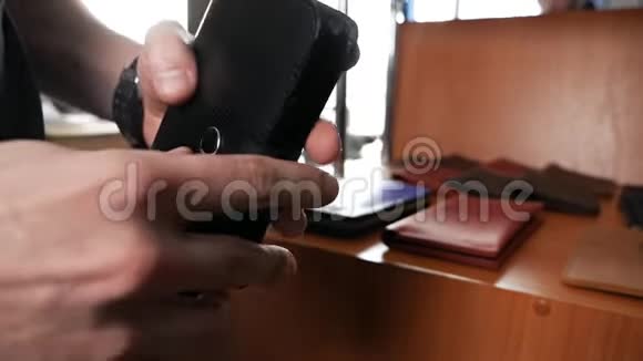 一只雄性手的特写皮夹在皮革内部手工制作的皮革制品视频的预览图
