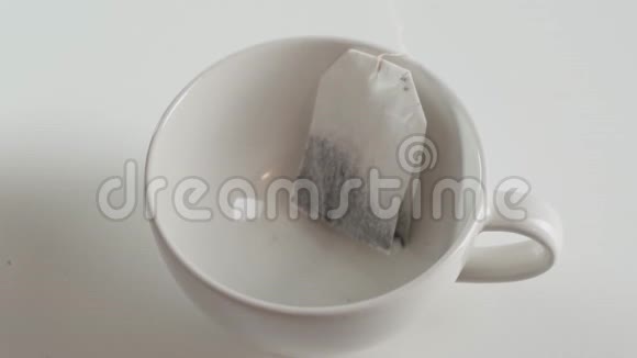 慢镜头茶袋是在一个白色的杯子里酿造的快关门视频的预览图
