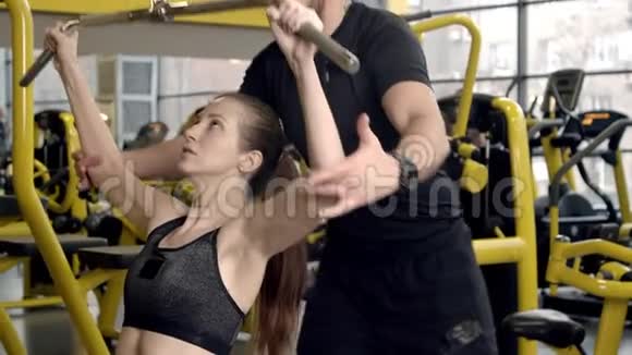 有教练在健身房工作的年轻女子视频的预览图