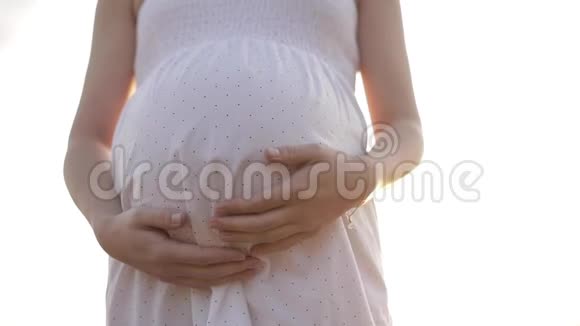 大肚子的年轻孕妇在户外摆姿势视频的预览图