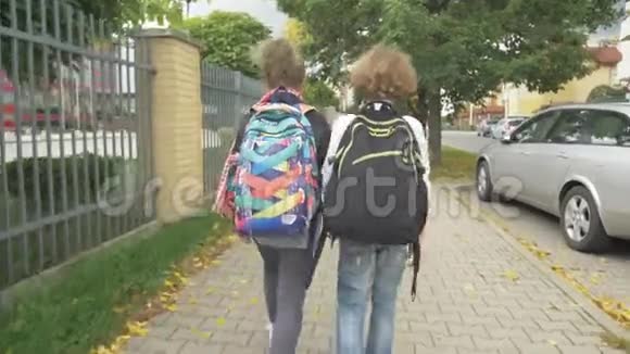 两个背包的朋友将在城市街道上的汽车上上学妹妹和她的哥哥回学校太阳是视频的预览图