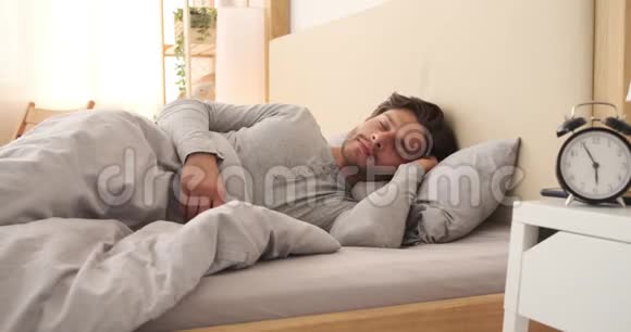 男人醒来后在床上用手机视频的预览图