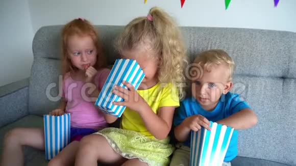 孩子们吃爆米花哭悲伤的孩子在家电影院看戏剧电影视频的预览图