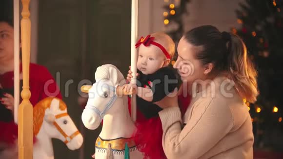 圣诞节概念微笑的母亲穿着米色毛衣和她的孩子在圣诞节工作室视频的预览图