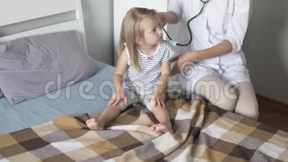 医生检查孩子的肚子用听诊器听女孩说话视频的预览图
