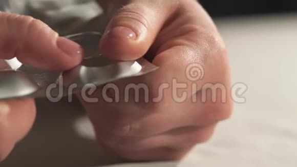 女性的手打开水泡包中的最后一粒药丸视频的预览图