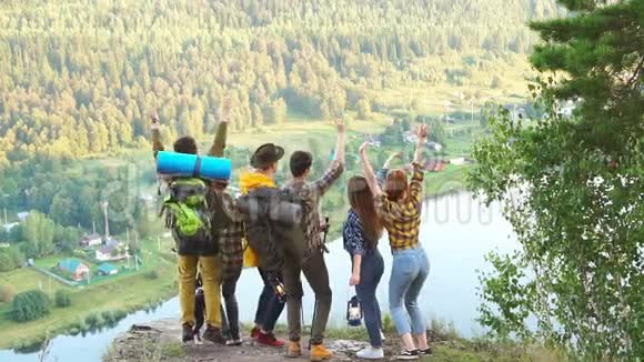 年轻的徒步旅行者对他们的攀登和成就感到高兴视频的预览图
