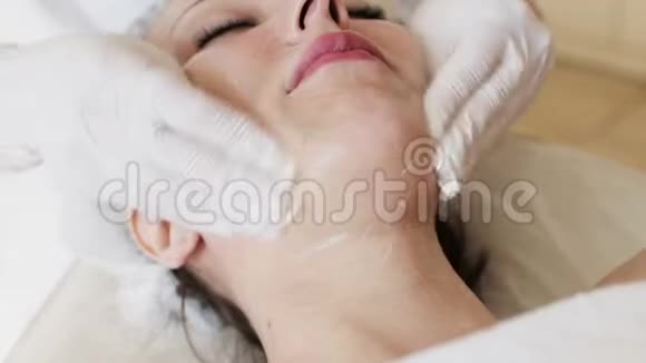 在美容水疗中心享受放松面部按摩的女性视频的预览图