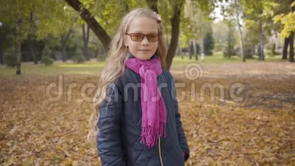 一个年轻的白种人少女戴着眼镜对着镜头眨眼睛逃跑的肖像年轻的金发少年视频的预览图