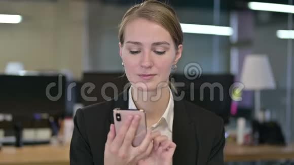 有魅力的年轻女商人使用智能手机的画像视频的预览图
