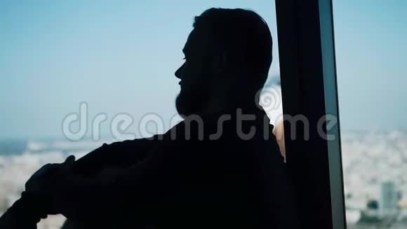 一个人坐在灯光的窗户旁边不错的剪影视频的预览图