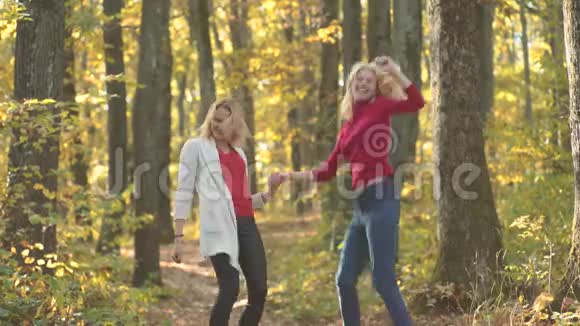 秋天女孩的户外滑稽肖像美丽的女孩在秋天公园玩得很开心有趣的秋舞姑娘们的迪斯科视频的预览图