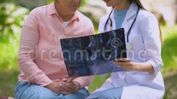 女性治疗师解释诊断病人显示x线图像医学视频的预览图