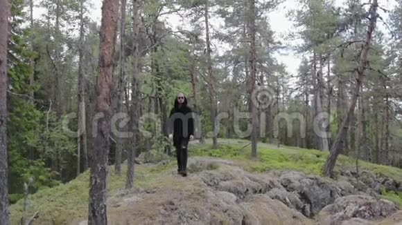 穿着黑色衣服的人独自走在一片深岩石林中旅行健康的积极生活方式冒险户外视频的预览图