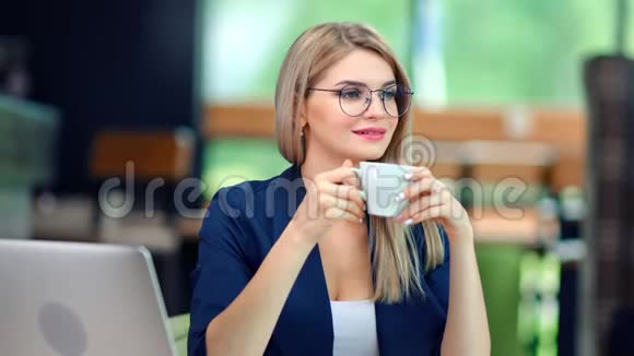轻松愉快的商务女性在现代办公背景下喝咖啡享受休息视频的预览图