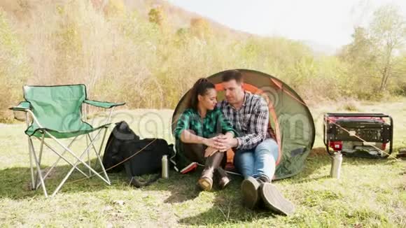 可爱的年轻夫妇在舒适的露营地拥抱视频的预览图