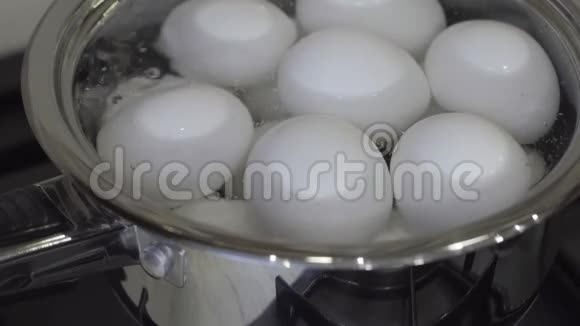 生的白鸡蛋在金属平底锅中煮熟健康早餐概念视频的预览图