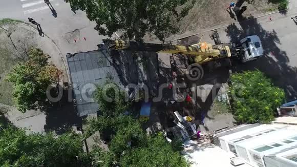 城市采用挖掘机进行鸟瞰拆除房屋挖掘机装载卡车视频的预览图