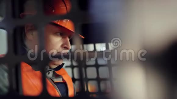 操作人员戴着头盔穿着工作服坐在新的装载机上研究如何操作视频的预览图